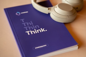 A pair of headphones beside a notebook, symbolizing the audio guidance that accompanies the Pathway process.
