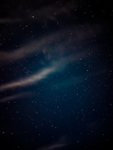 A serene night sky with soft clouds, symbolizing comfort and relaxation.