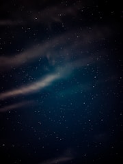 A serene night sky with soft ambient light reflecting calmness.