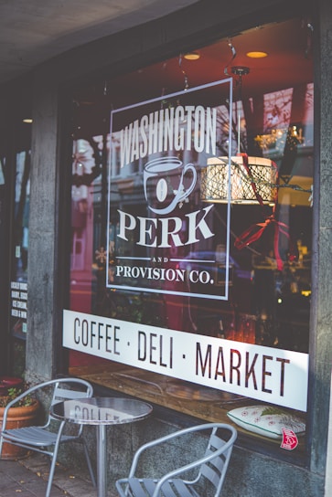 Exterior view of Adams Morgan Elevation Shop storefront at 2461 18th St NW, Washington, DC, with warm lighting.