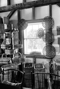 Handwoven rattan baskets displayed on a rustic wooden table with natural sunlight.