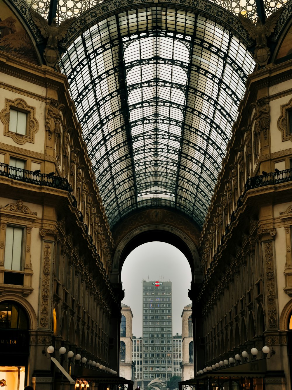 a large building with a glass roof and a clock