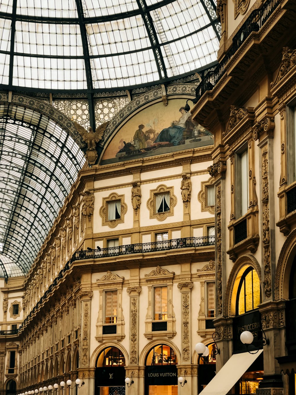 a large building with a glass ceiling and a clock