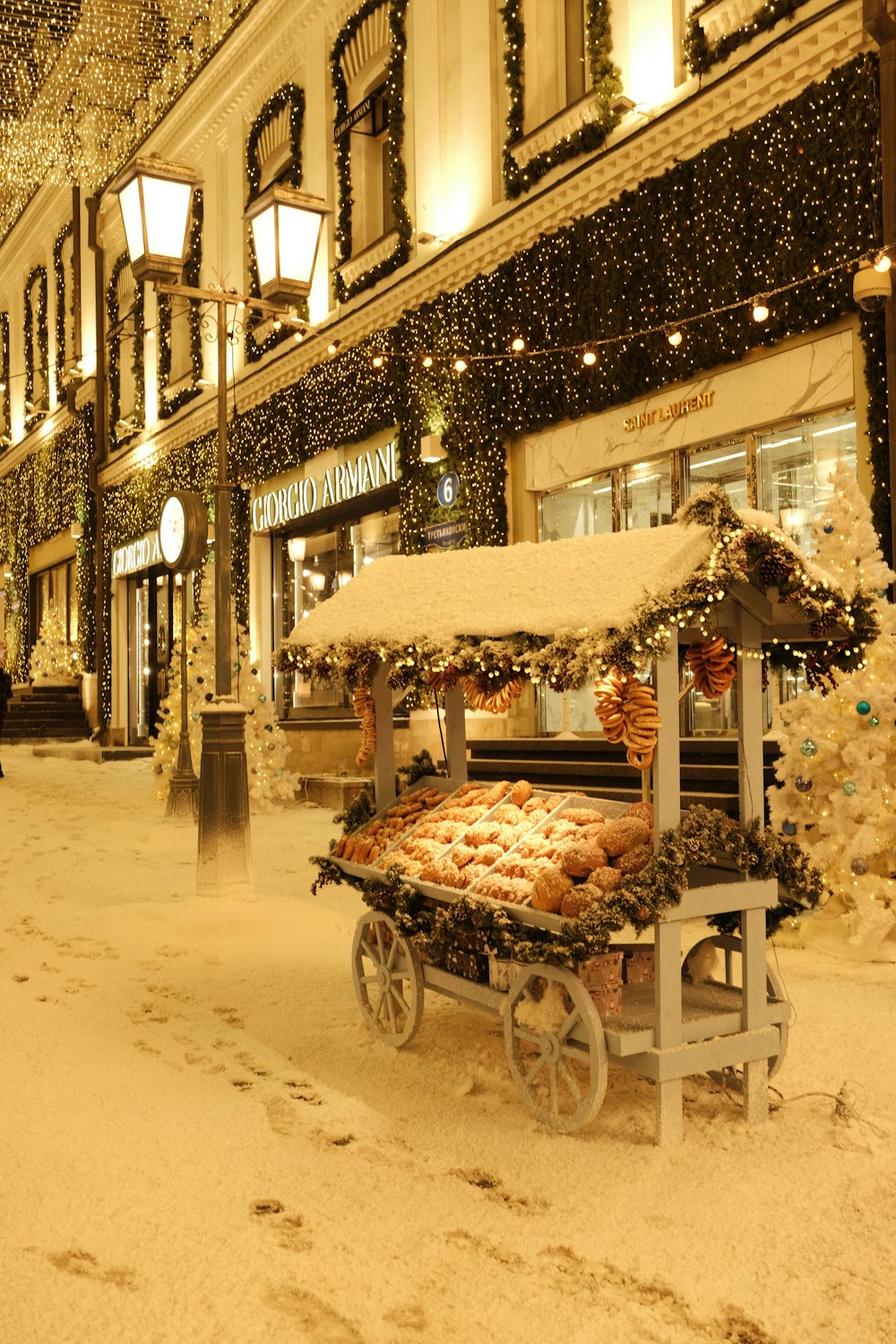 a christmas display in the middle of a snowy street