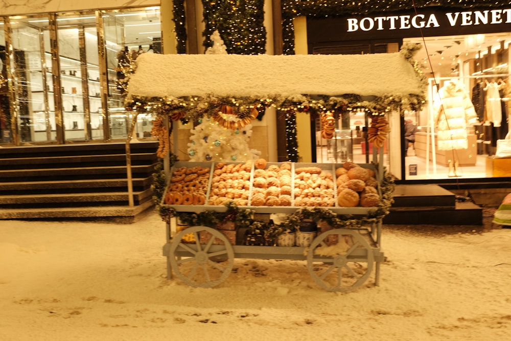 a cart full of donuts in front of a store