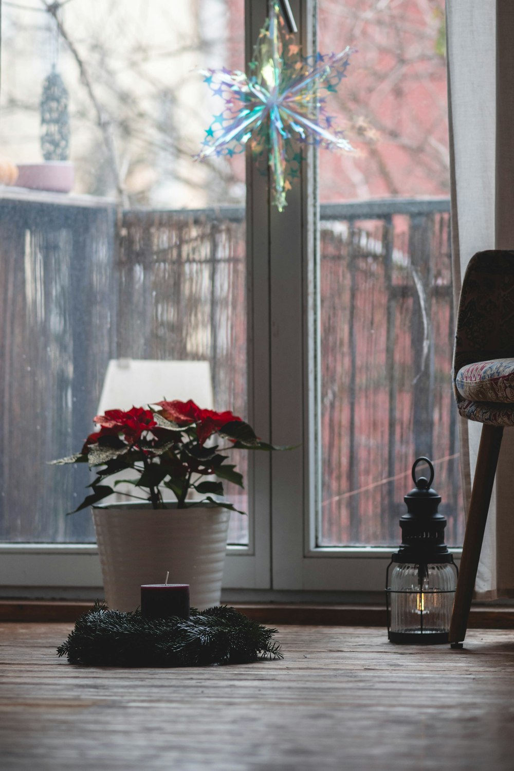 a room with a chair and a potted plant on the floor