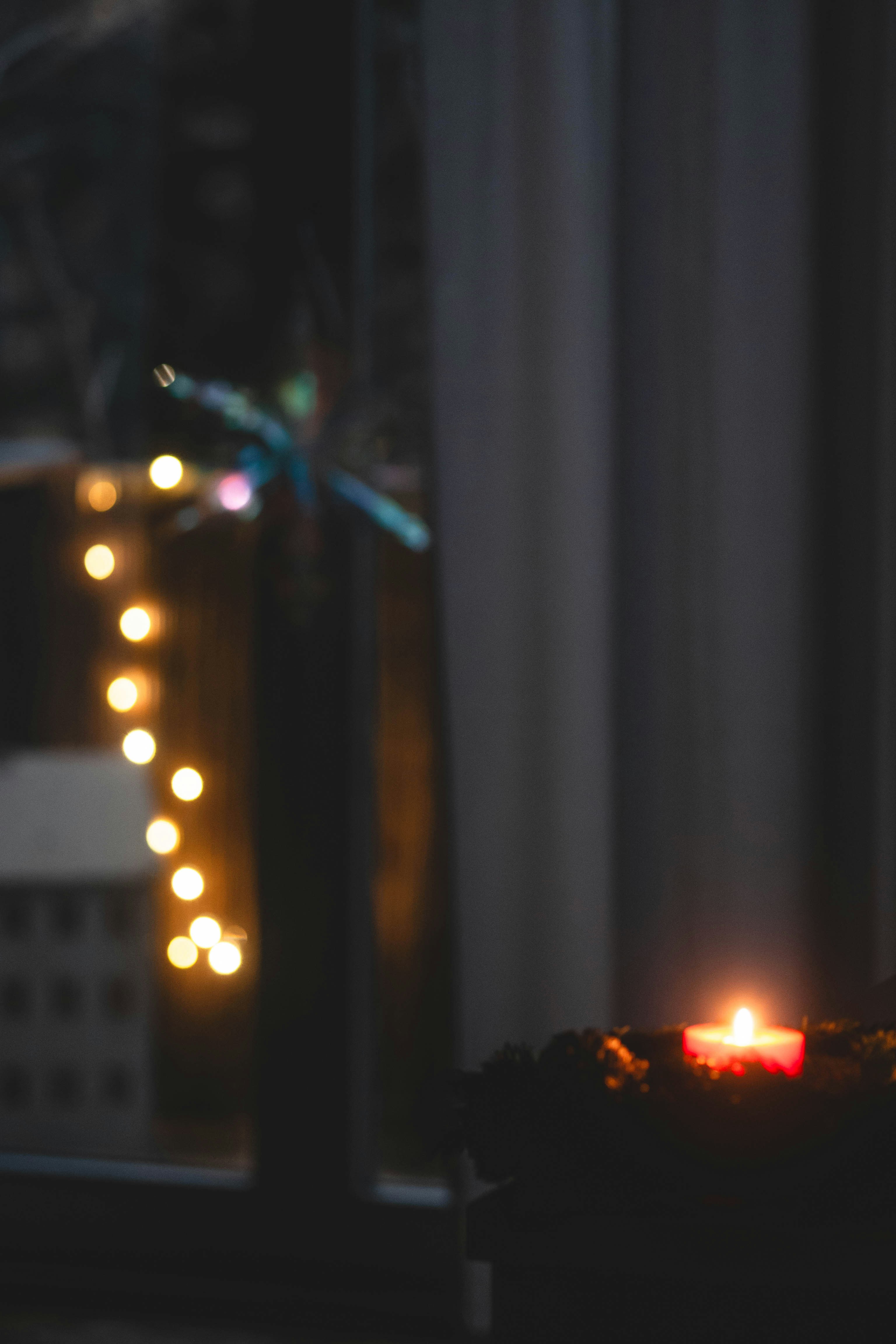 a lit candle sitting on top of a table