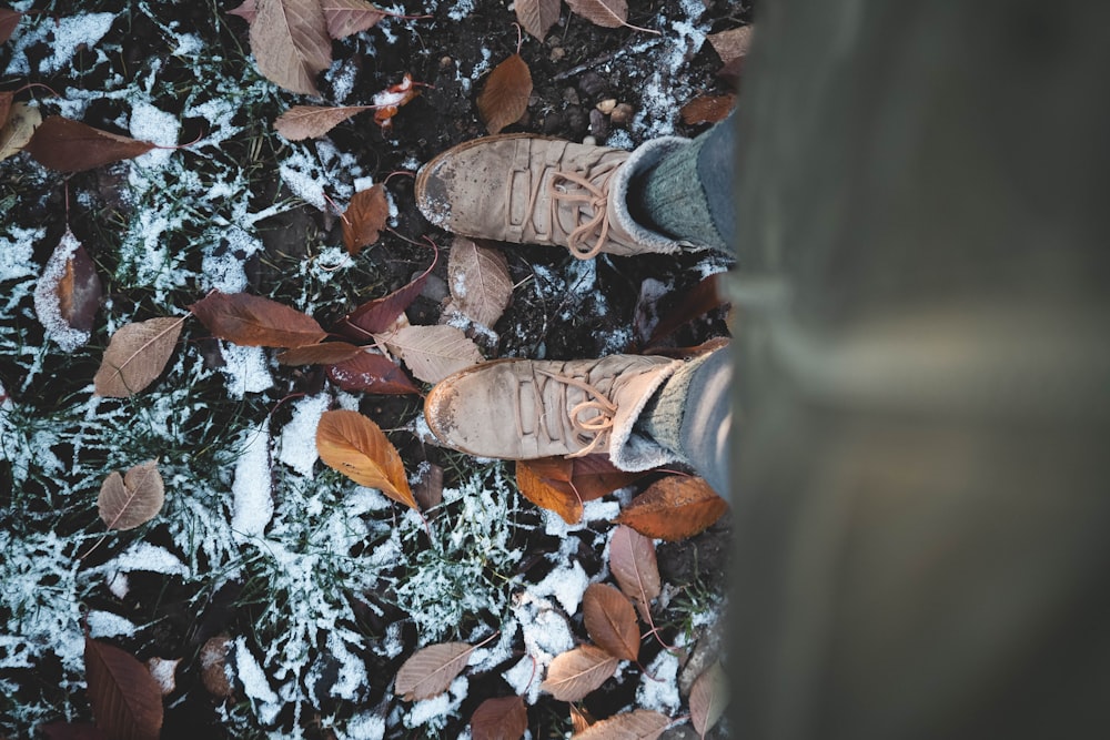 a person standing in the snow with their shoes on