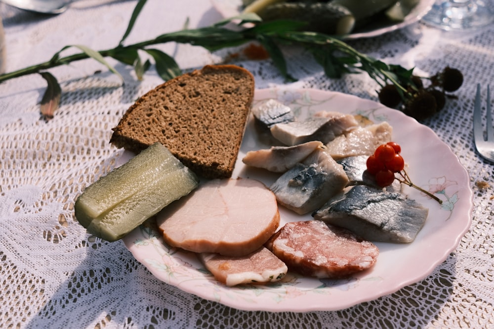 a white plate topped with meat and bread