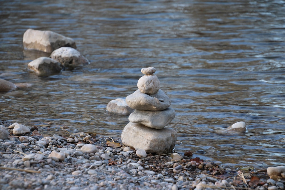 a pile of rocks sitting on top of a river