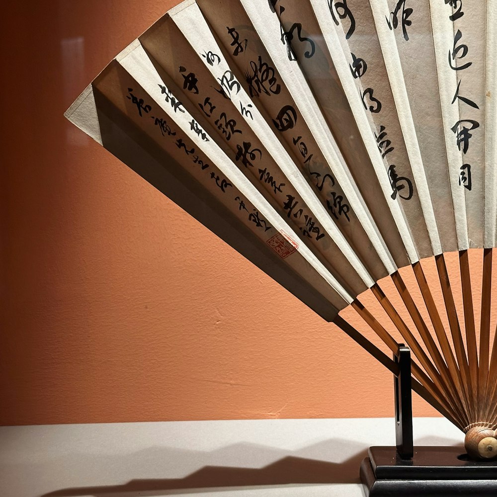 a japanese fan sitting on top of a table