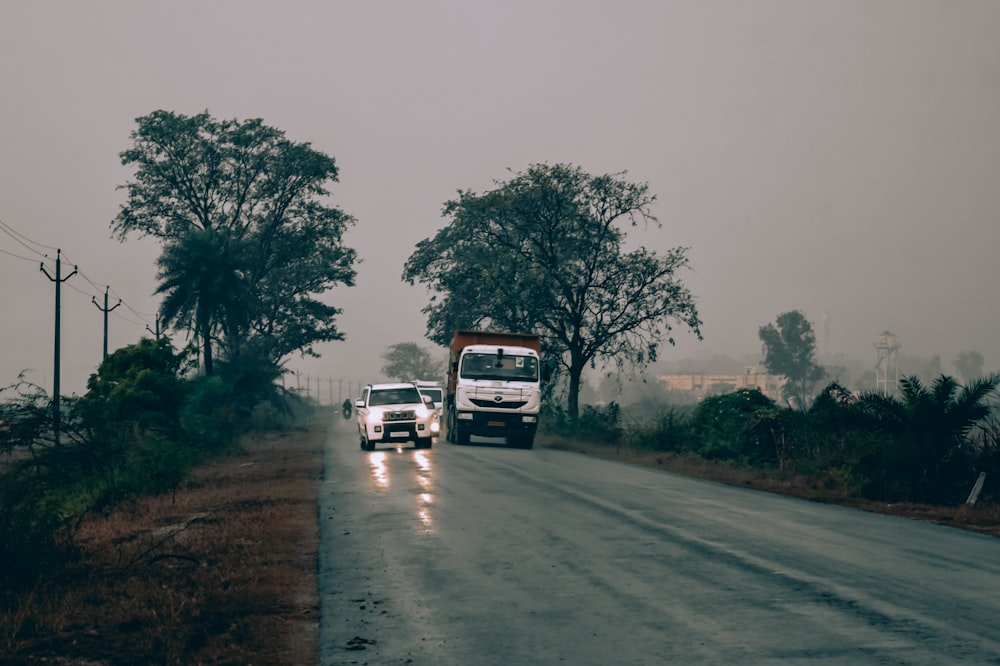 a couple of trucks driving down a road