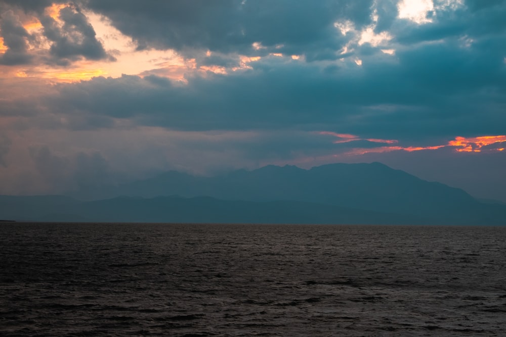 a large body of water under a cloudy sky