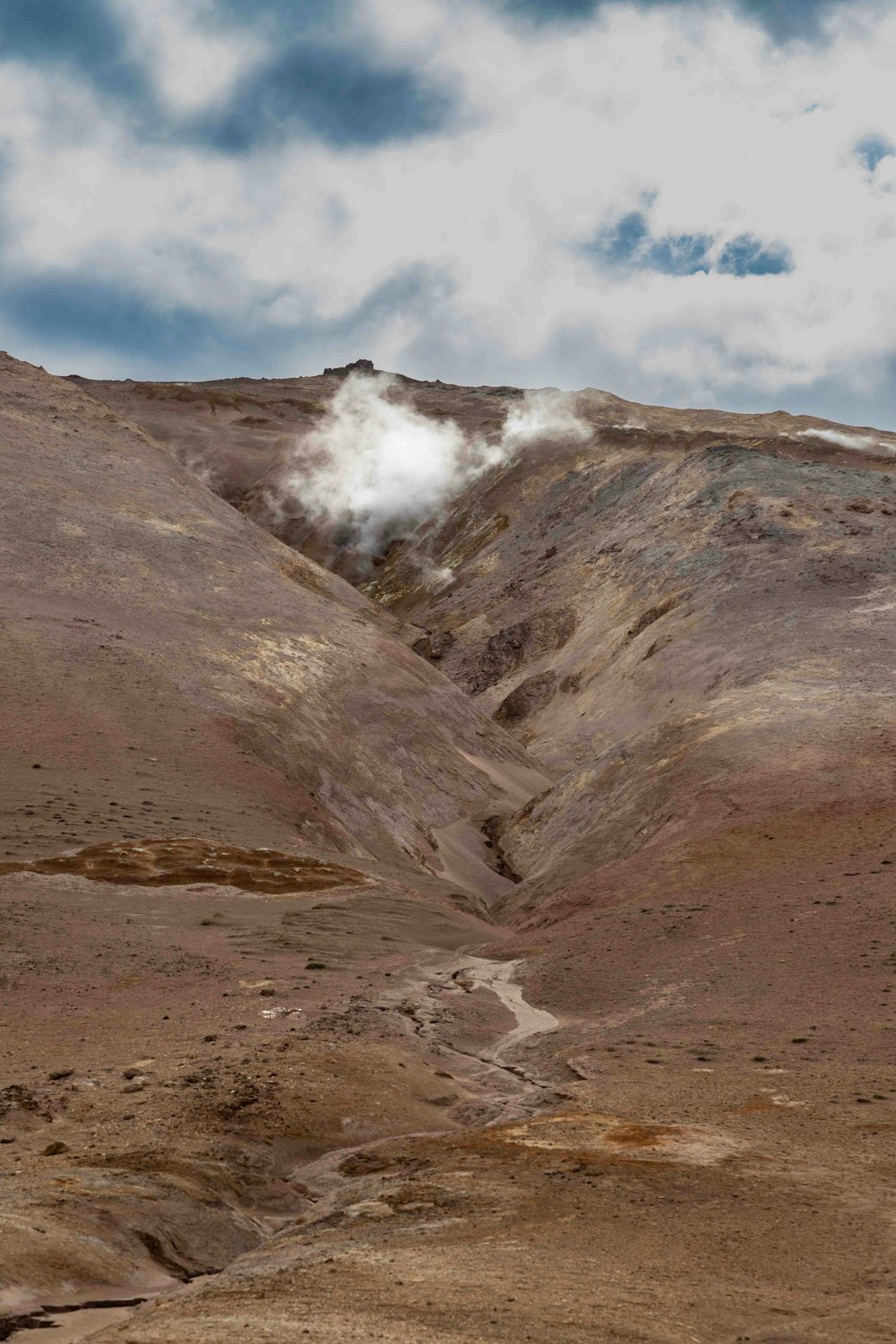 there is a mountain with steam coming out of it