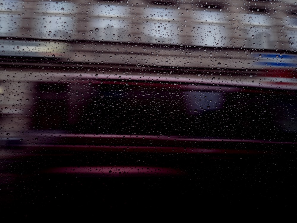 rain drops on a window with a building in the background