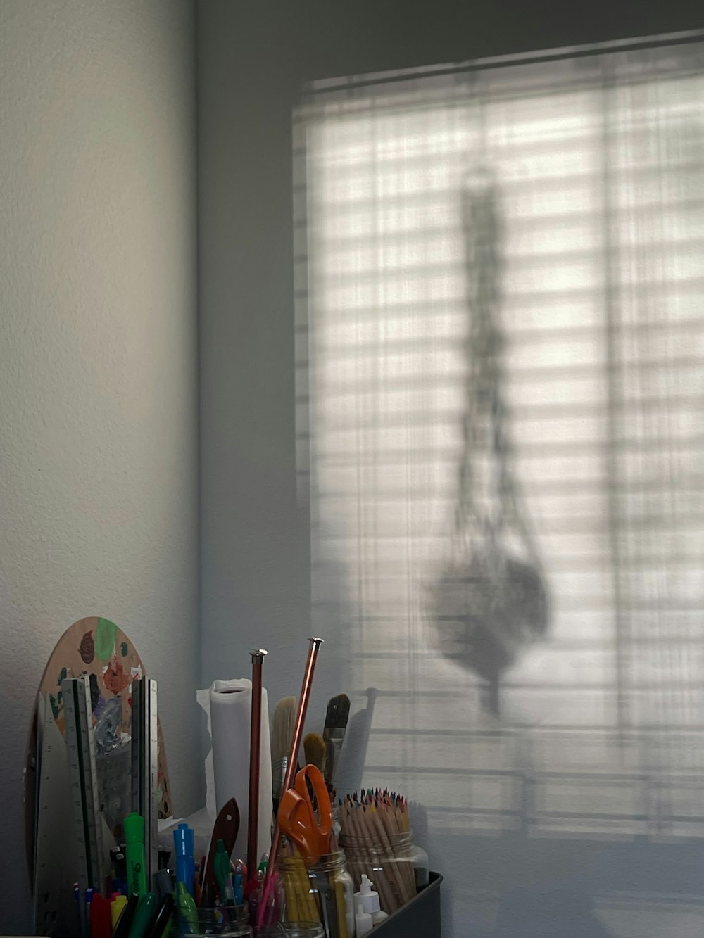 the shadow of a person's hand on a window sill