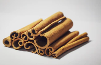 a pile of cinnamon sticks sitting on top of a white table