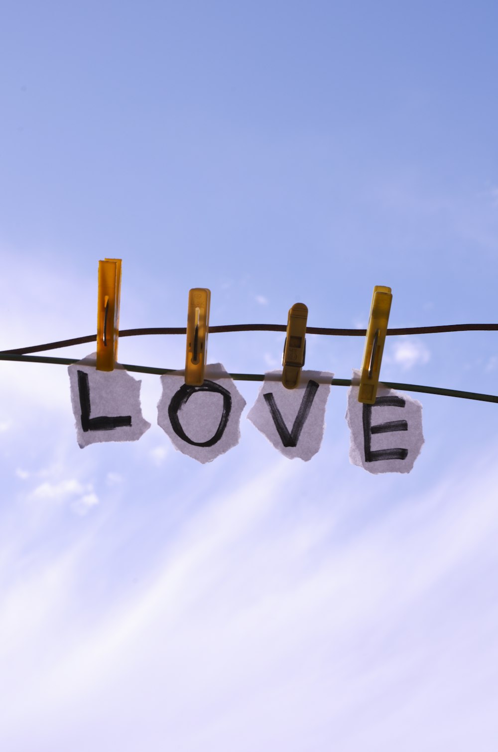 a couple of clothes pins hanging from a clothes line