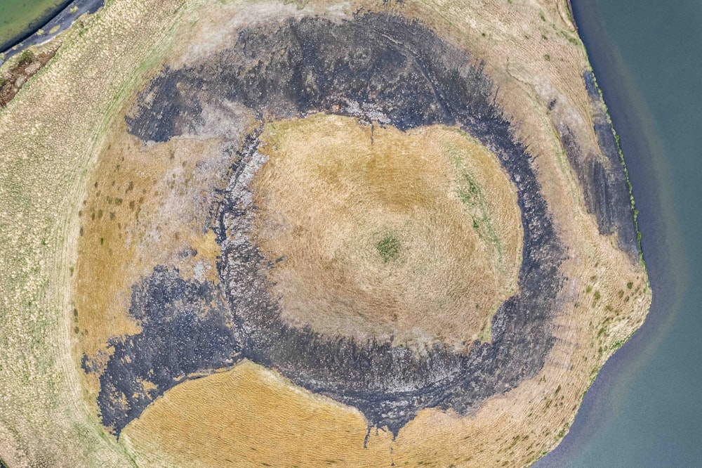 an aerial view of an island with a circular hole in the middle