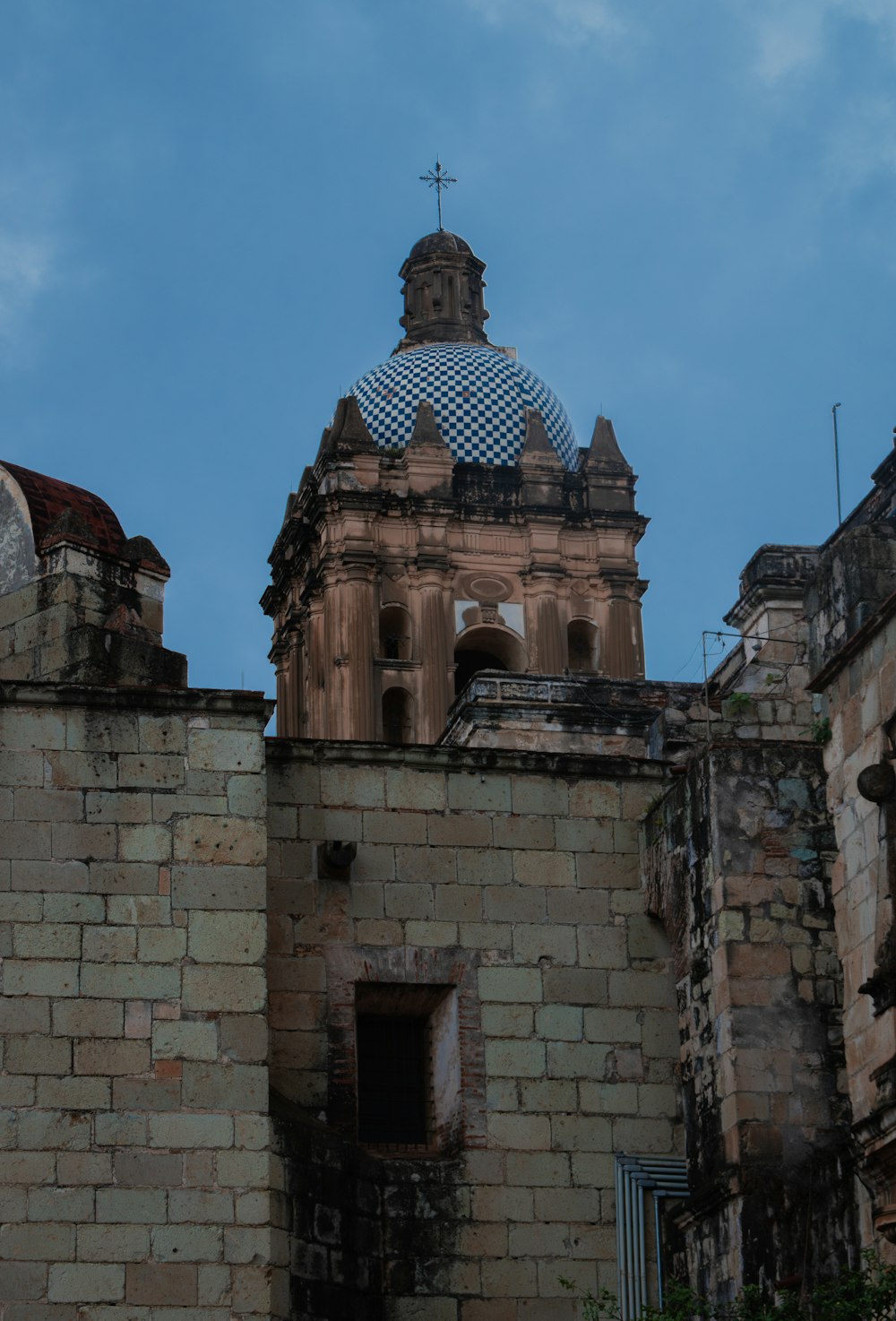 a large brick building with a cross on top of it