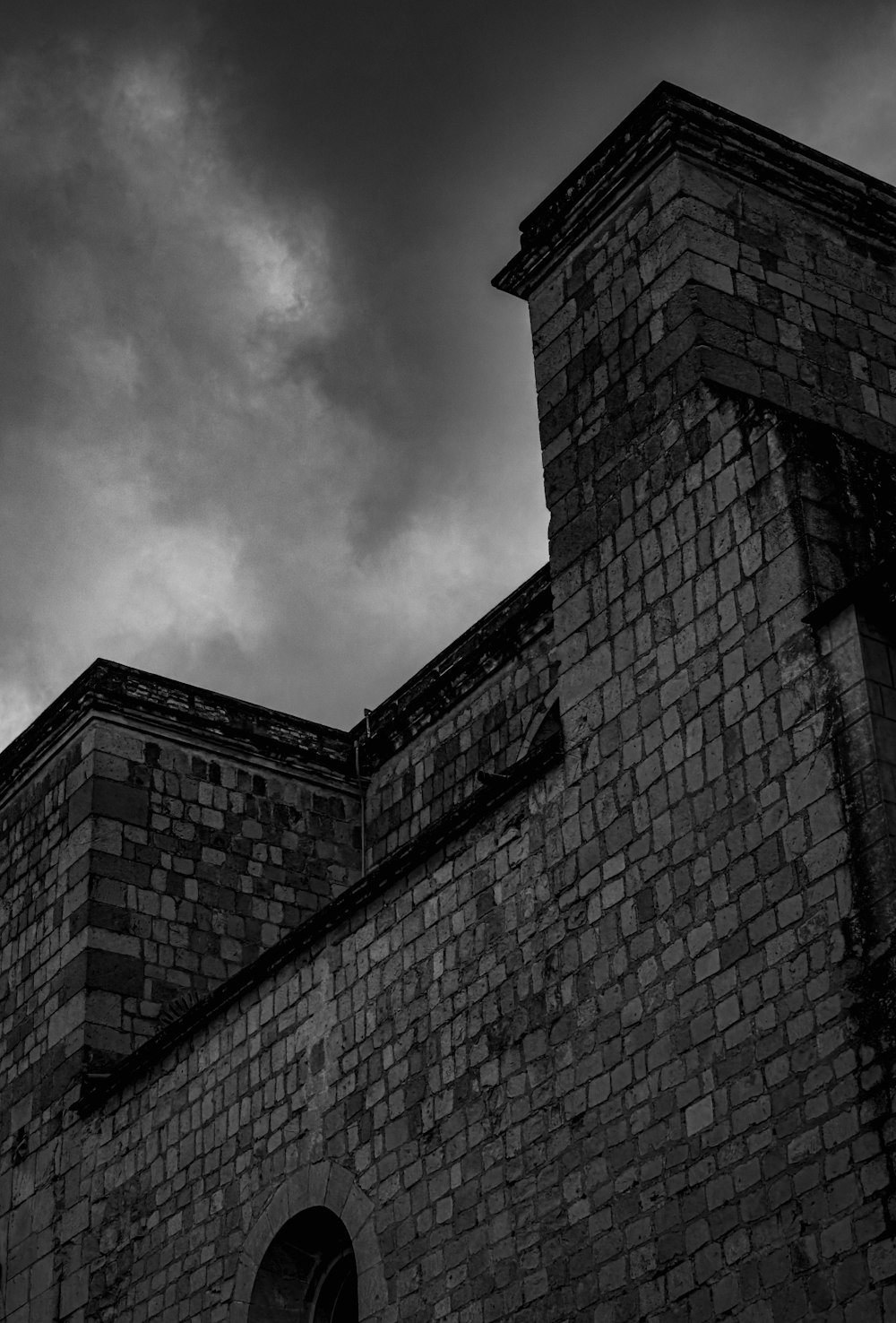 a black and white photo of a brick building