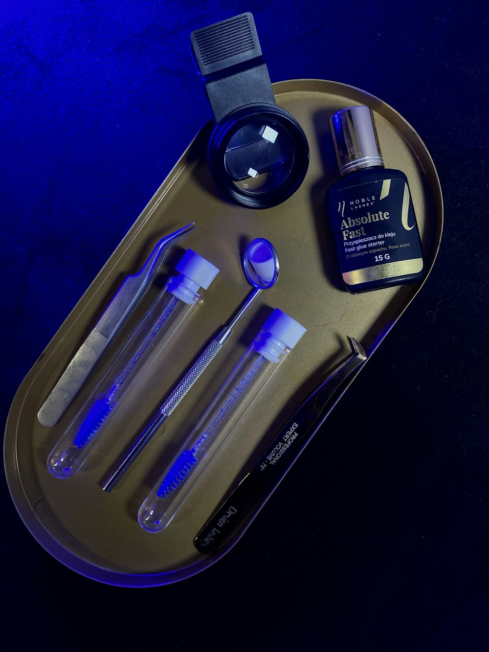 a tray with a bottle, spoons, and other items on it