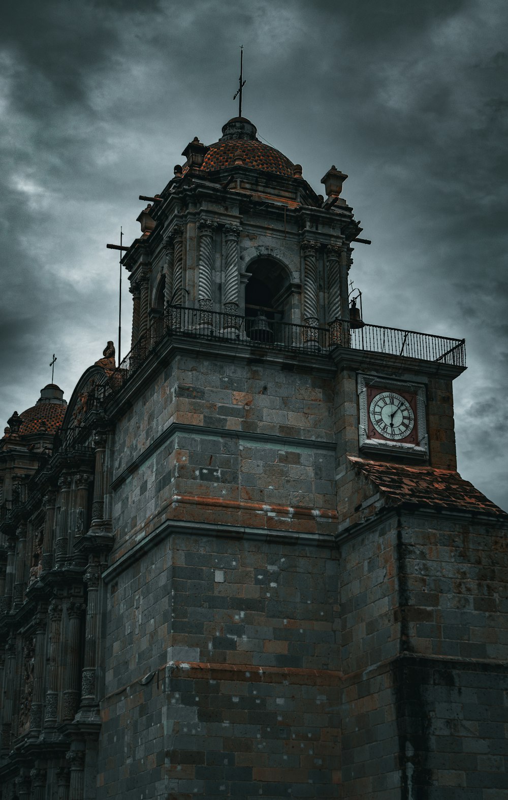 a clock tower with a cloudy sky in the background