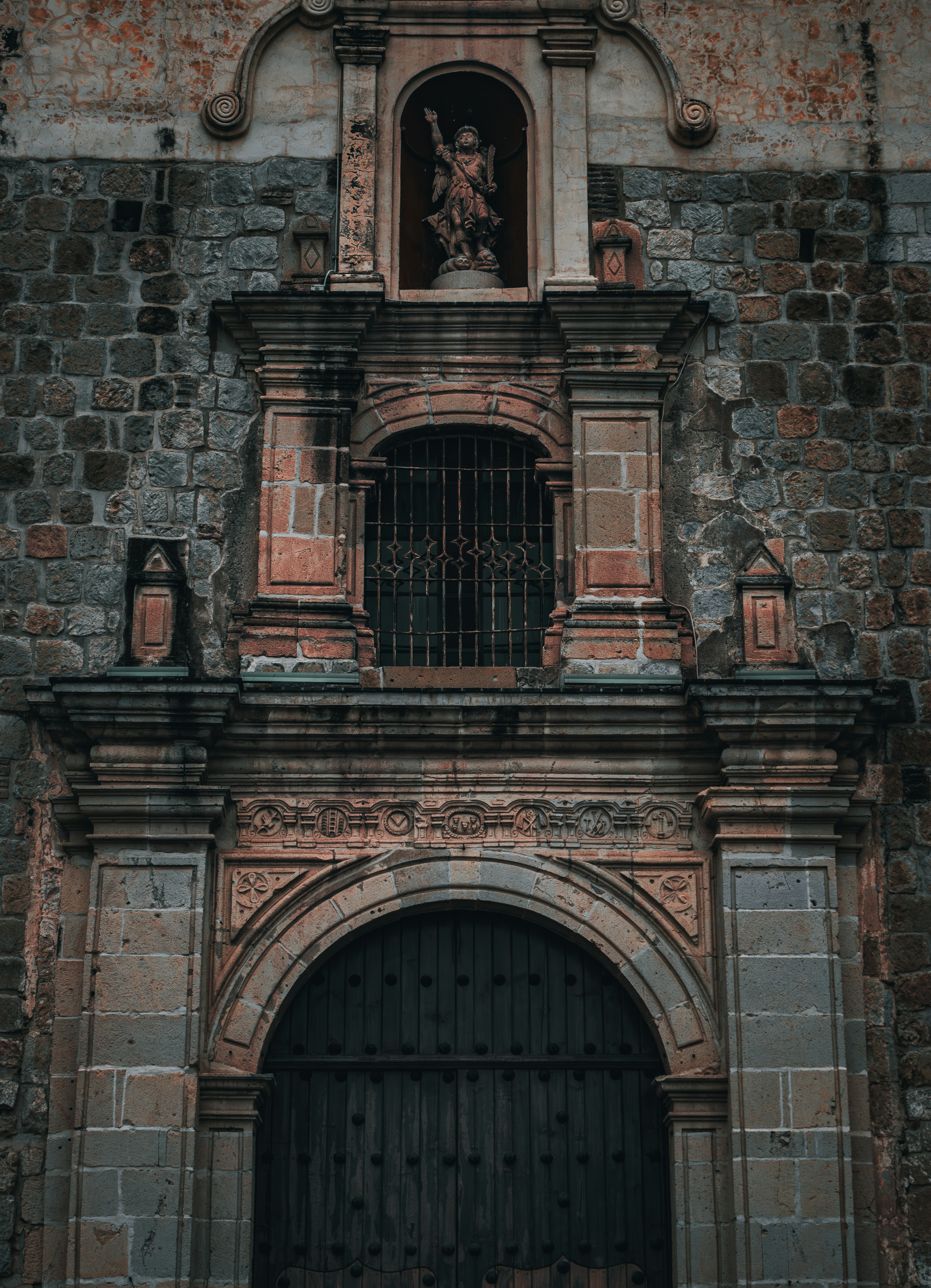 an old brick building with a clock on it