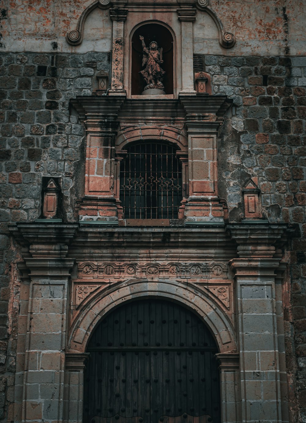 an old brick building with a clock on it