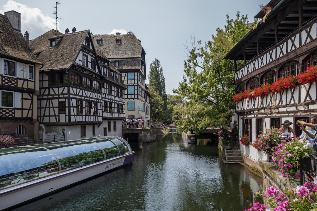 a river running through a city next to tall buildings,