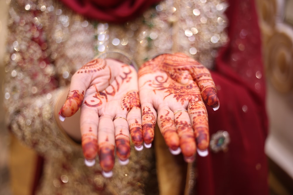 a close up of a person's hands with hennap