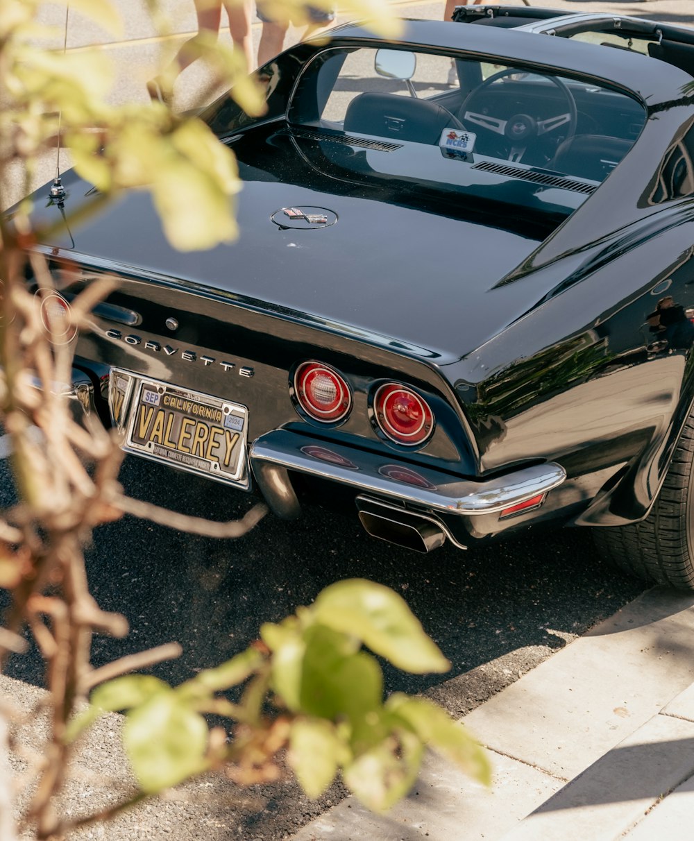 a black car parked on the side of the road