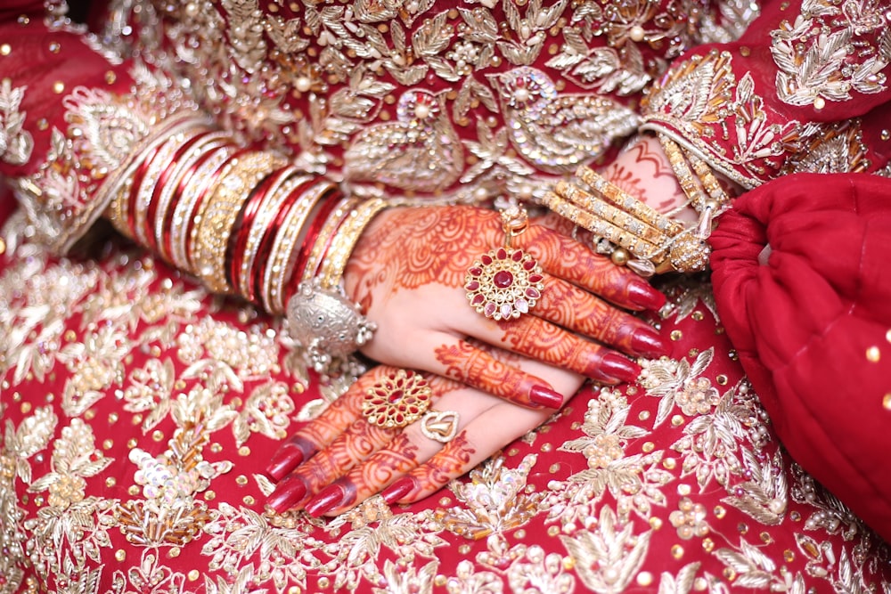 a close up of a woman's hands with hennap