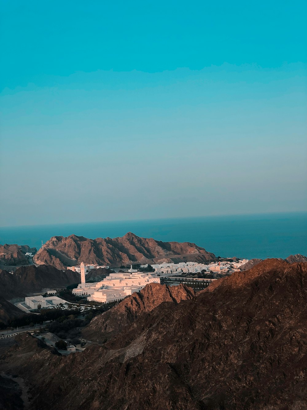 a view of a mountain with a body of water in the distance