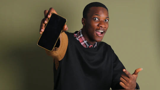 A hand holding a smartphone displaying a lottery results page with excitement.