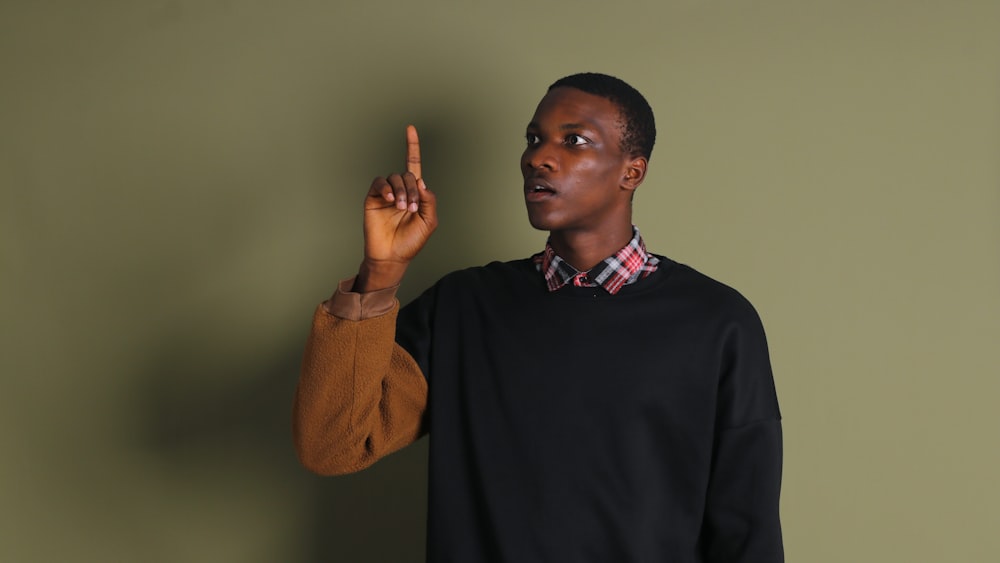 a man pointing at something with his finger