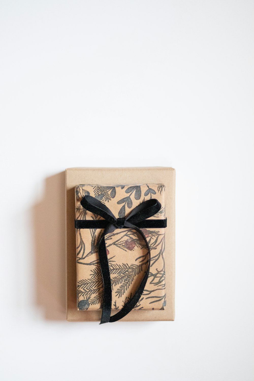 a wrapped gift box with a black ribbon