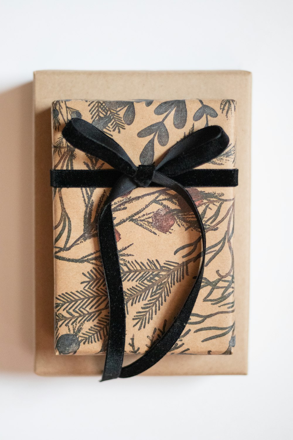 a wrapped gift box with a black ribbon