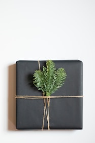 a present wrapped in black paper and tied with twine