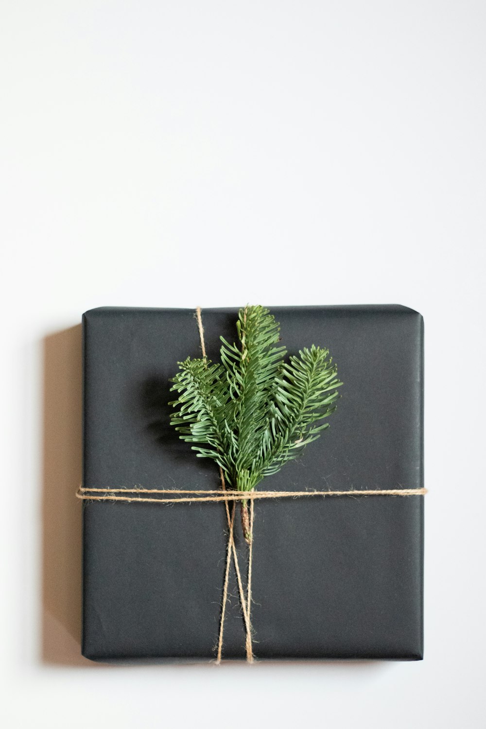 a present wrapped in black paper and tied with twine