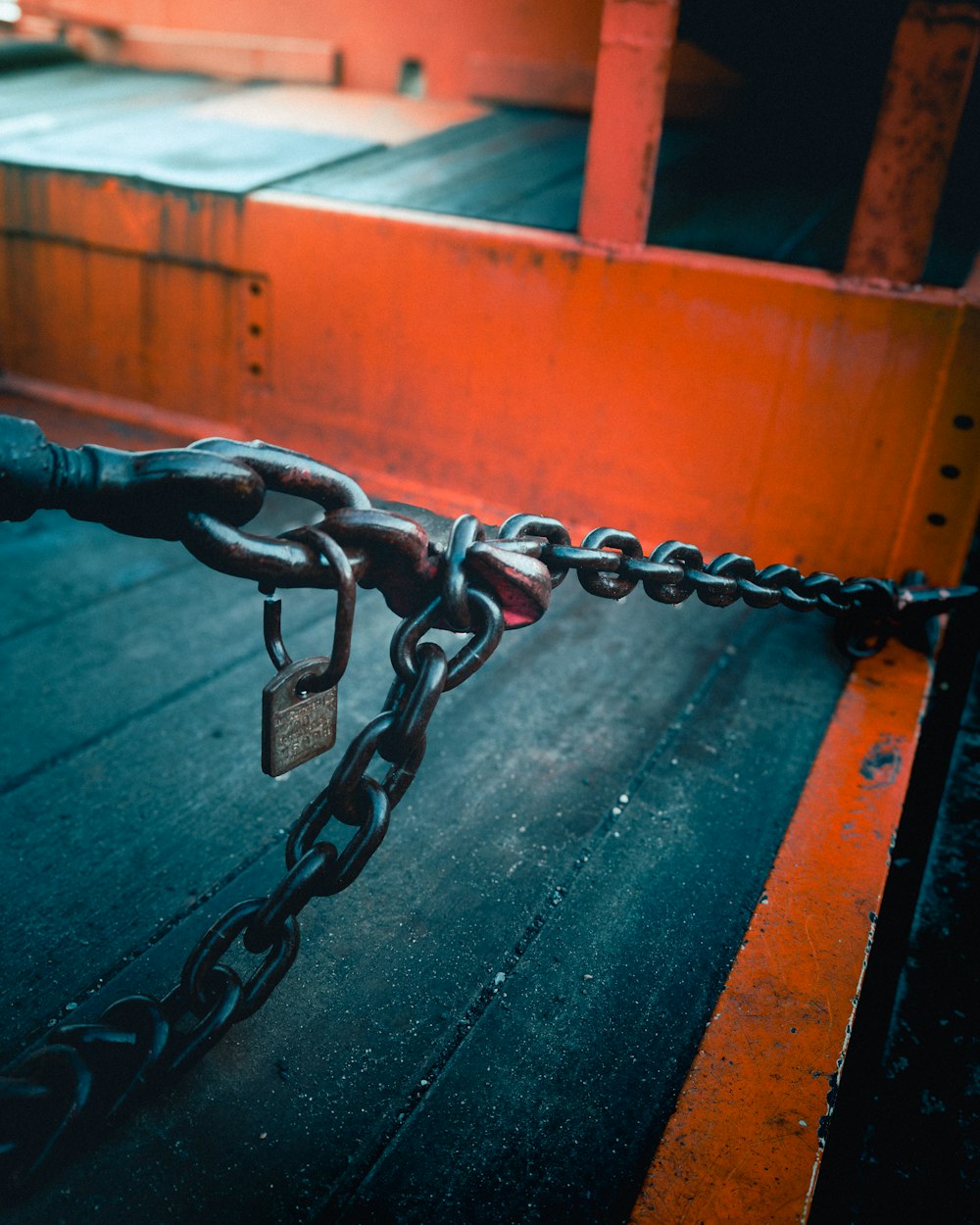 a close up of a chain and padlock on a boat