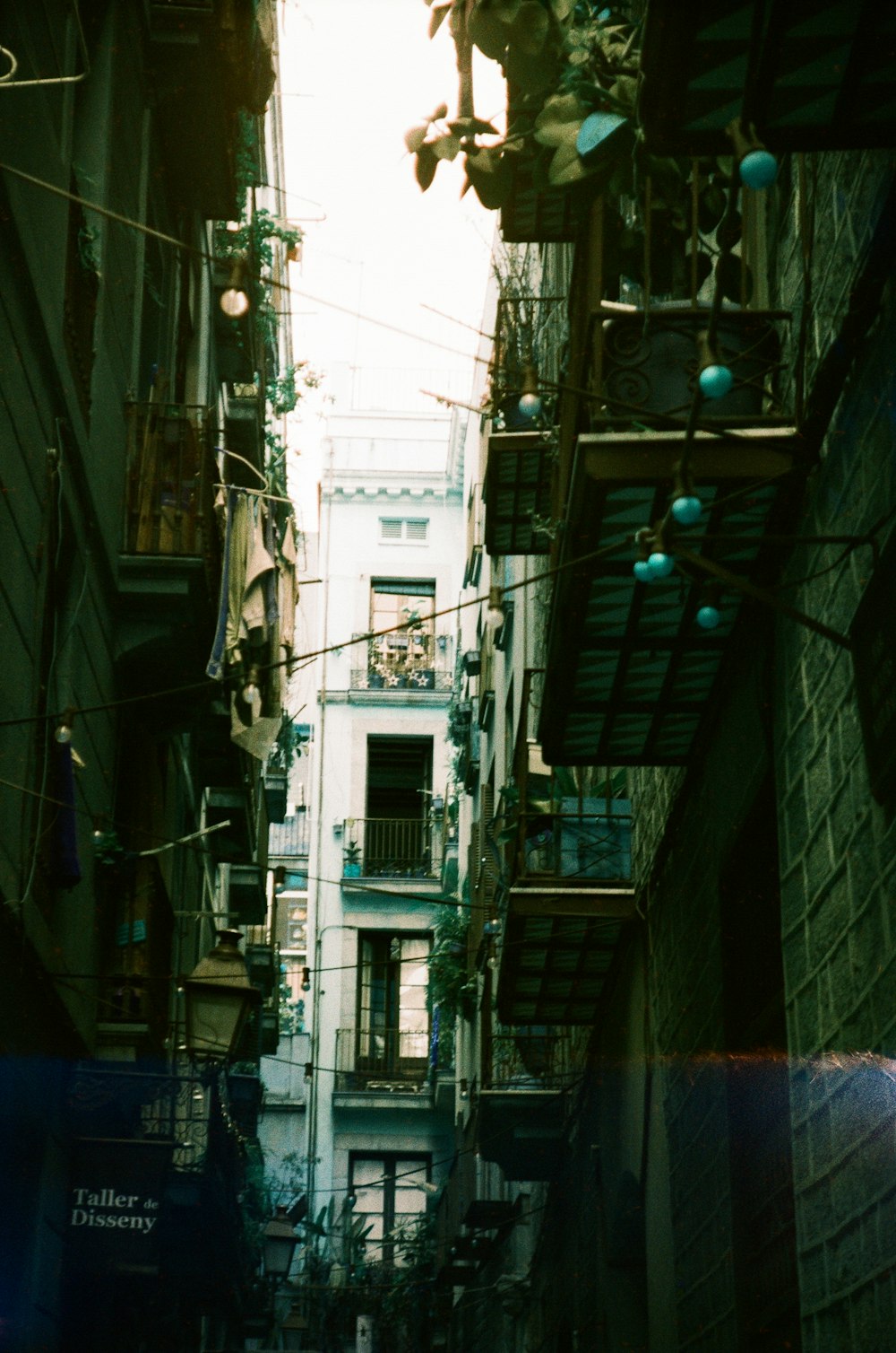 a narrow alleyway with lots of windows and balconies