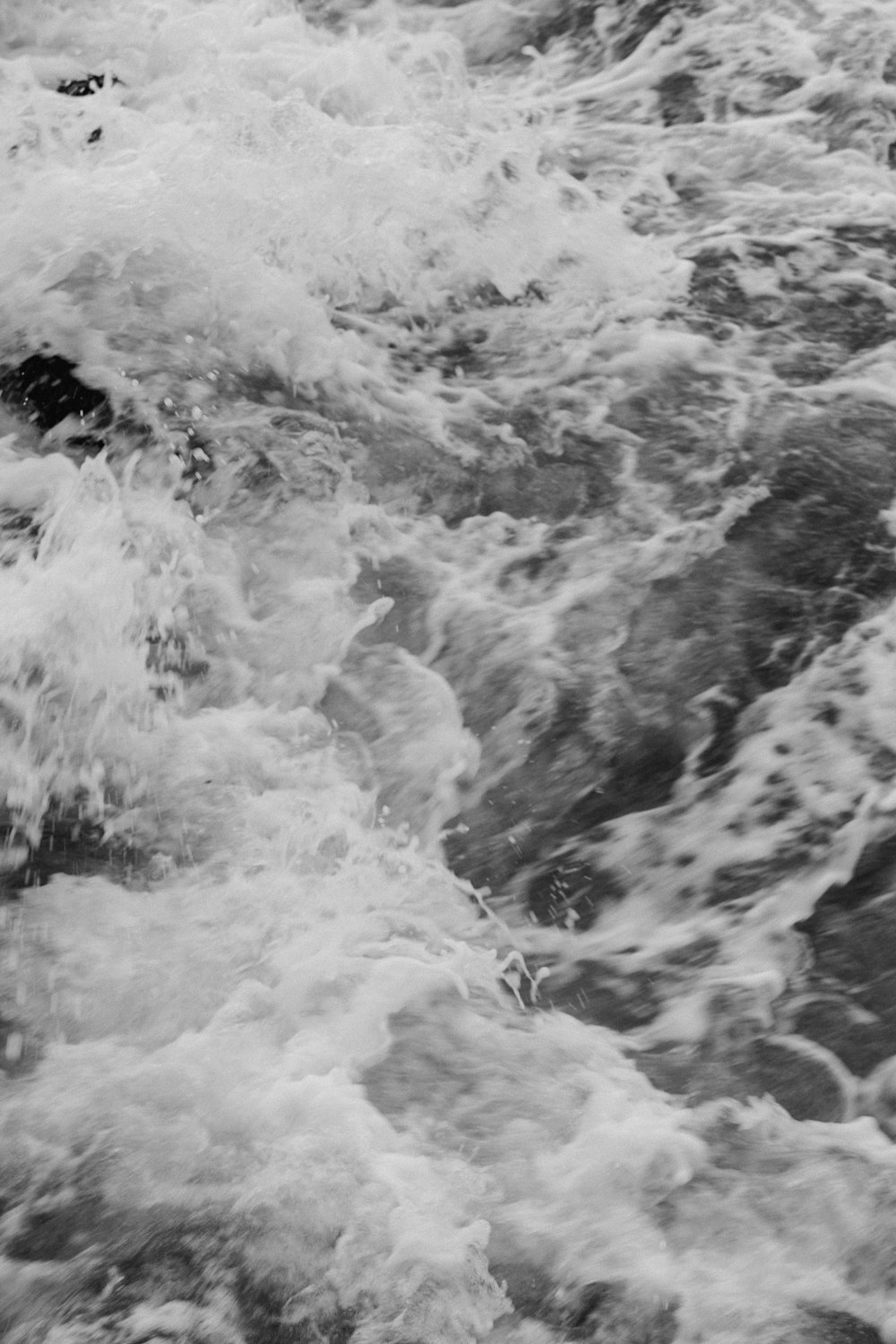 a black and white photo of the ocean waves