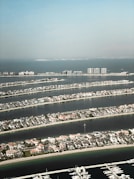 an aerial view of a marina and a city