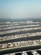 an aerial view of a marina and a city