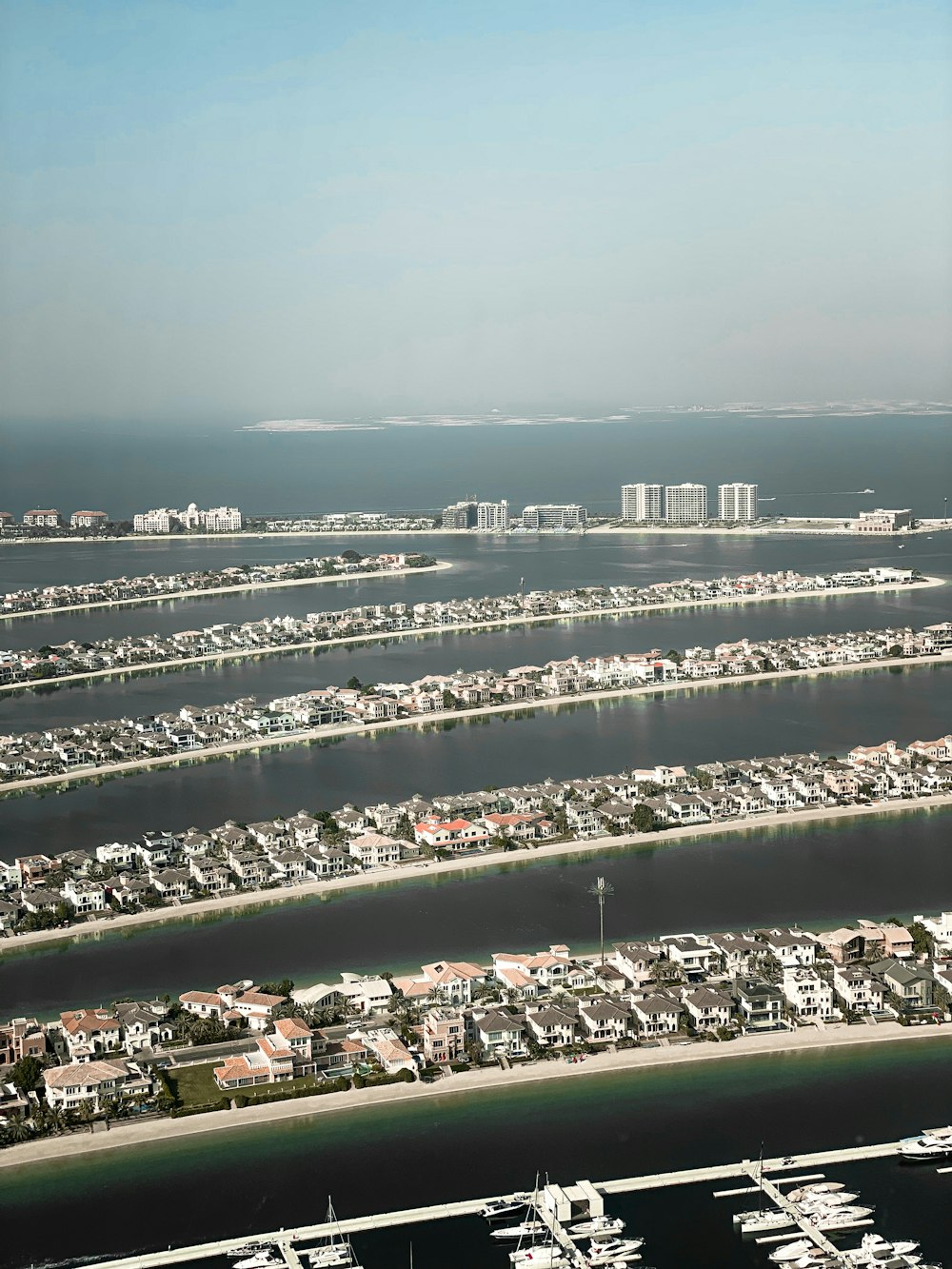 an aerial view of a marina and a city