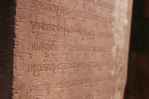 Detailed carvings in an ancient script on a stone surface. The text appears to be well-preserved, and the stone has a warm, earthy color.