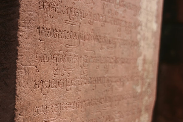 Close-up of a detailed ancient inscription studied by Dr. Prasad.