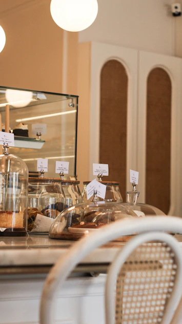 Cozy interior of saboría with warm lighting and a display of freshly baked goods.