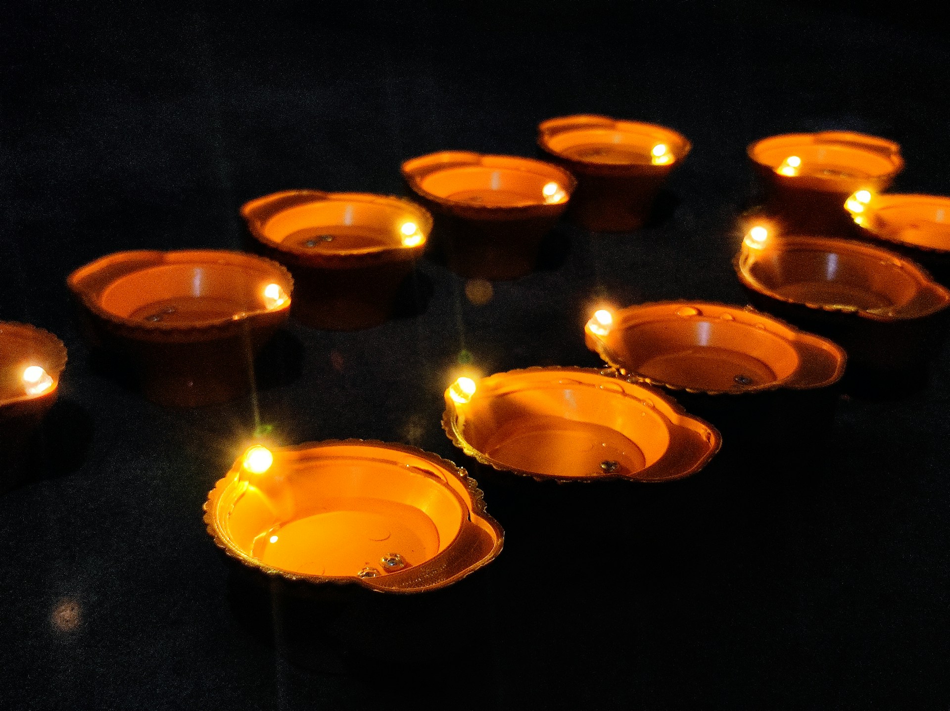 a group of lit candles sitting on top of a table